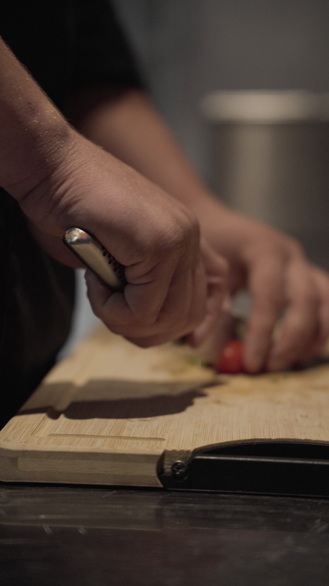 Yaro snijdt groenten op de plank